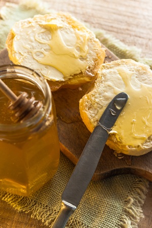 Roll and sweet honey on wooden backgroundの写真素材