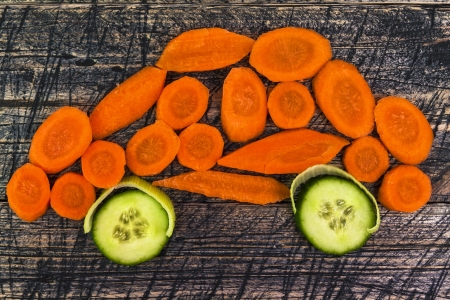 Composition with early vegetables on wooden boardの写真素材