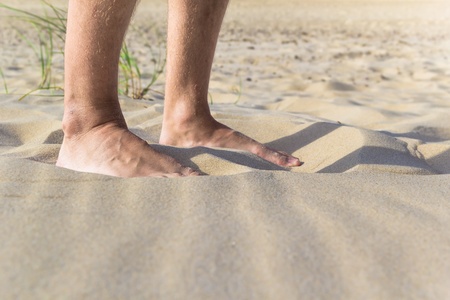View of the legs on the beach - close-upの写真素材