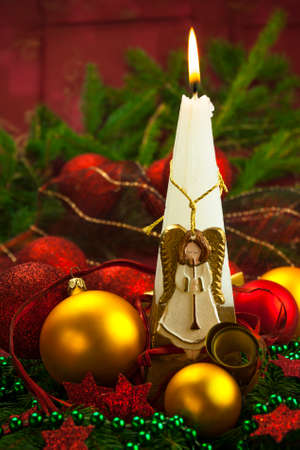 Christmas card with burning candle and angelの写真素材