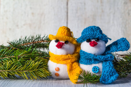 Plush soft snowmen on white wooden backgroundの写真素材