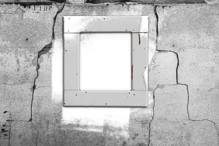 Old cracked wall with a window frame and white streaks of paintの写真素材