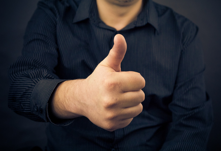 Closeup of man hand showing thumbs upの写真素材
