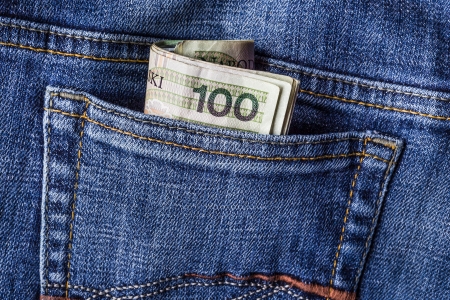Several Polish banknotes in jeans pocket