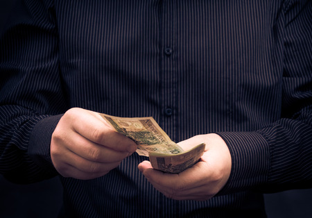 Closeup of a man for calculating Polish money