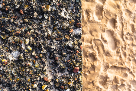 Concrete wall with colorful pebbles and sandの写真素材