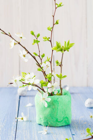 Spring blooming twigs on a wooden tableの写真素材