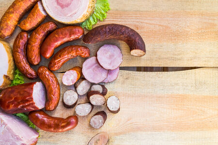 Smoked meat on a wooden table with empty space for textの写真素材