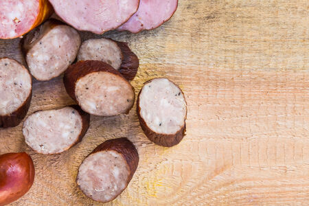 Smoked meat on a wooden table with empty space for textの写真素材