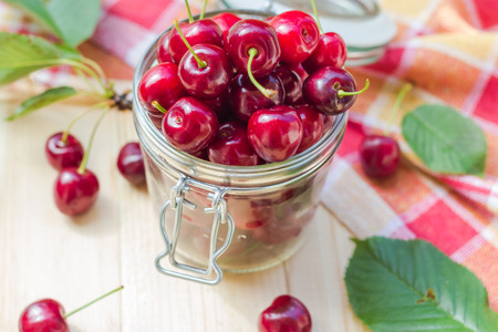 Summer fruits: closeup of cherries in a jar for processed