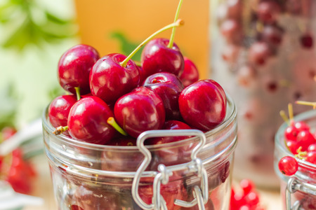 Summer fruits: closeup of cherries in a jar for processedの写真素材