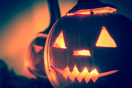 Halloween pumpkins with cut faces and candlesの写真素材