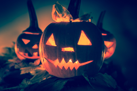 Halloween pumpkins with cut faces and candlesの写真素材