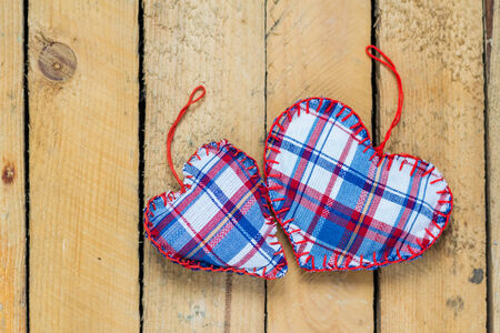 Valentine's background: Handstitched hearts on a wooden tableの写真素材