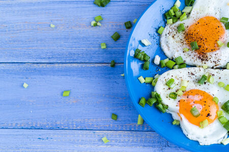 Valentines delicious breakfast: fried eggs in the shape of heartsの写真素材