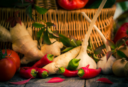 Small peppers and various vegetables on the kitchen tableの写真素材
