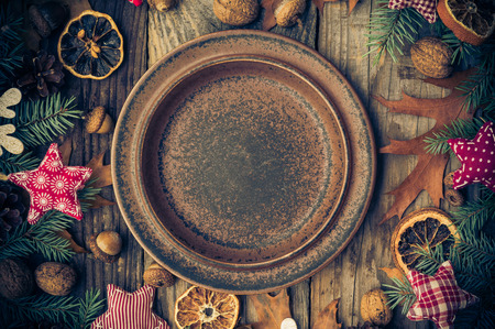Festive table with a plate and decorations as well as gifts of natureの写真素材