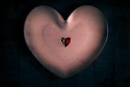 Many colorful little hearts on the wooden background