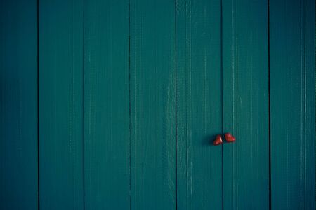 Many colorful little hearts on the wooden backgroundの写真素材