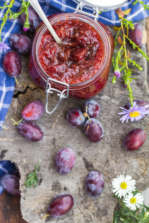Late summer in the kitchen: a jar of plum jamの写真素材
