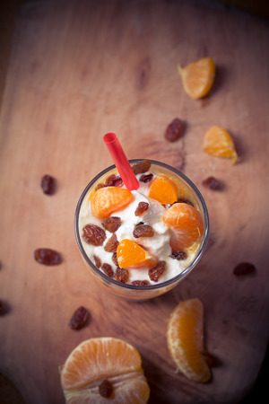 Fresh fruit mandarin with yoghurt and raisinsの写真素材