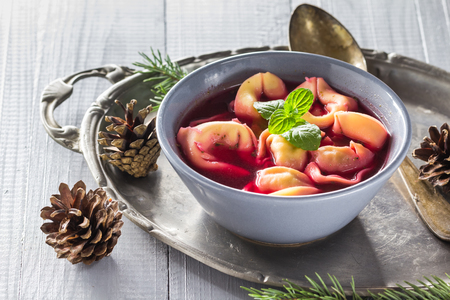 Traditional homemade red borscht with dumplings on Christmas tableの写真素材