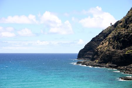 Lighthouse over blue ocean in Hawaiiの写真素材