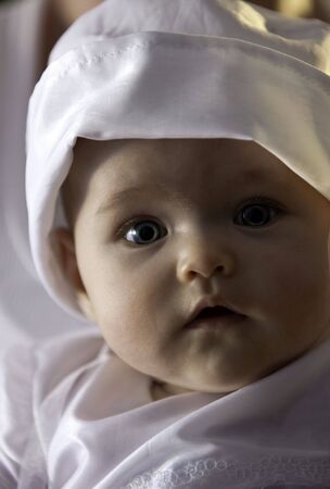 A portrait of a baby girl wearing a hatの写真素材