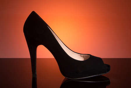 Black female shoes on a blue backgroundの写真素材