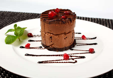a slice of black chocolate cake with red cherry