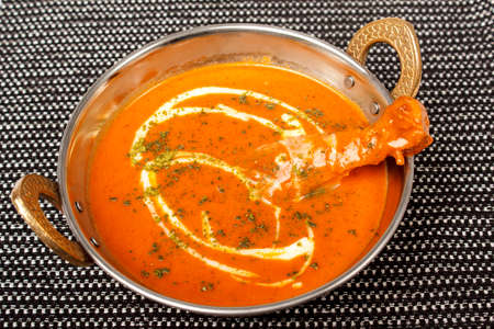 Pumpkin and carrot soup with cream and parsleyの写真素材