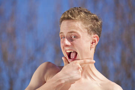 A 14 years old teenager making faces and looking into the cameraの写真素材