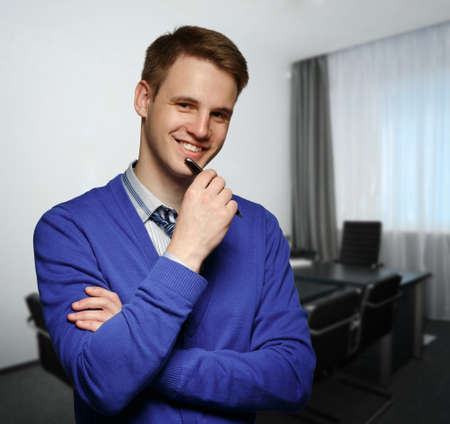 Young successful business man at office
