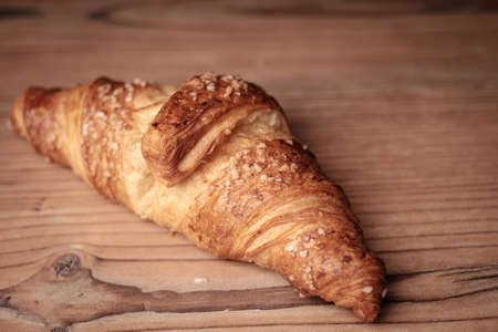 Fresh Croissant on a wooden backgroundの写真素材