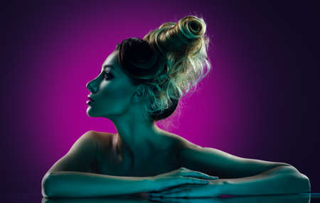Low key portrait of a beautiful girl with creative hairstyle.