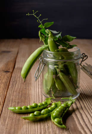 Ripe Green peas on wooden tableの写真素材
