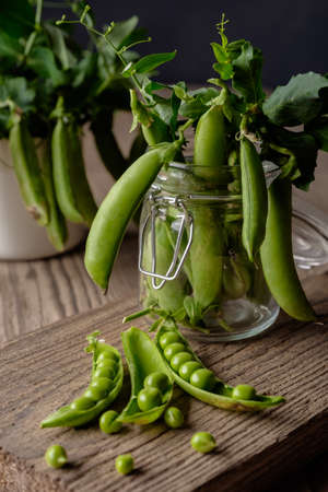 Ripe Green peas on wooden tableの写真素材