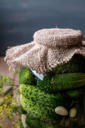 Jar of pickles on wooden table. Salted Cucumbers still-life.の写真素材
