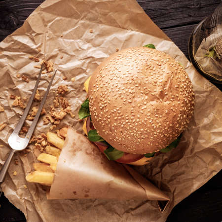Classic burger and chips on the wooden table. Top view.の写真素材