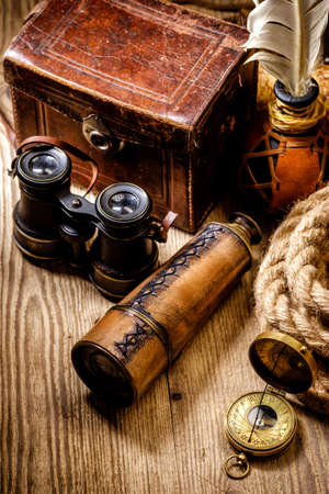 Vintage grunge still life. Antique items on wooden table. Travel geography concept.の写真素材