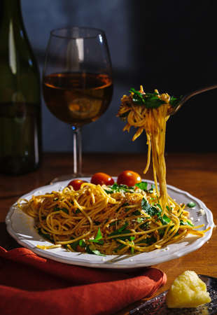 Spaghetti on a fork. Pasta with fresh tomatoes and herbsの写真素材