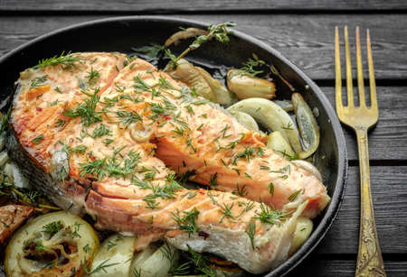 Salmon steak with vegetables on a grill pan.の写真素材