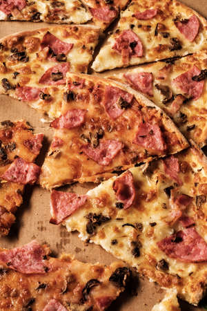Slices of pizza on cardboard. Top view. Close-up.の写真素材