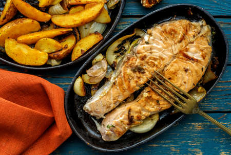 Salmon steak with vegetables on a grill pan.