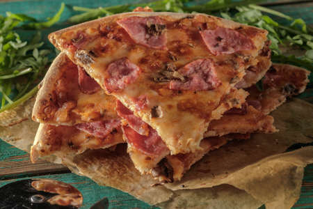 Slices of pizza on wooden table.の写真素材