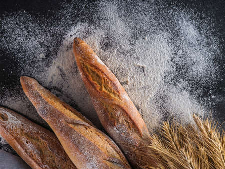Fresh baguettes on a dark table