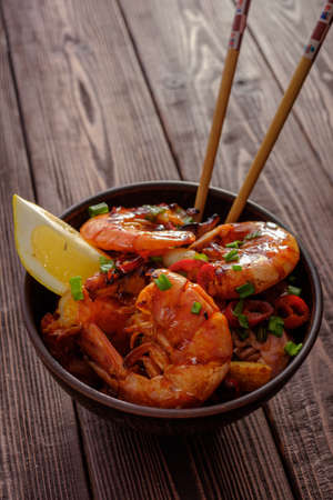 Large grilled BBQ shrimp with sweet chili sauce, green onion and lemonの写真素材