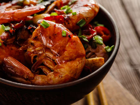 Large grilled BBQ shrimp with sweet chili sauce, green onion and lemon. Close up.の写真素材