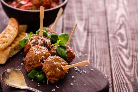 Delicious homemade meat balls with tomato sauce on skewers. Copyspace.の写真素材