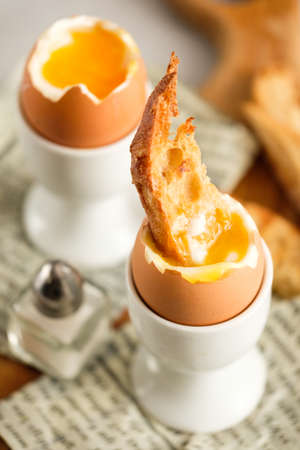 Soft boiled chicken egg for breakfast, with toastの写真素材